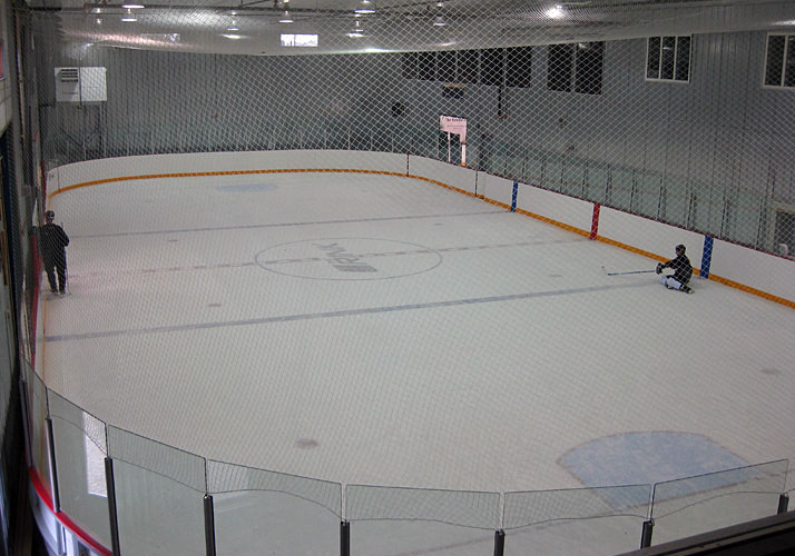 Indoor year round training rink with refrigeration, rink boards and glass. 